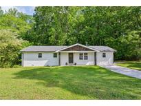 Charming single-story home with a well-maintained lawn and inviting front entrance at 3344 Ridgecrest Dr, Powder Springs, GA 30127