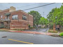 Mill Town Lofts exterior featuring brick facade, secure gate, and manicured landscaping near downtown at 791 Wylie Se St # 410, Atlanta, GA 30316