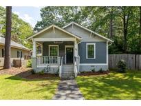 Charming craftsman-style home with a welcoming front porch and freshly landscaped yard at 23 Clifton Ne St, Atlanta, GA 30317