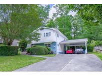 Charming two-story home with a carport and well-maintained landscaping creating a welcoming curb appeal at 2592 Dresden Dr, Atlanta, GA 30341