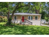 Charming brick home with a red front door and freshly landscaped front yard at 3456 Maryvale Dr, Decatur, GA 30032
