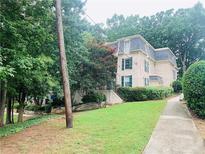 Two-story brick building with green shutters and landscaping along the sidewalk at 2805 Ne Expressway Unit A24, Atlanta, GA 30345