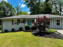Charming single-story home with well-manicured lawn and inviting blue door at 3153 Bonway Dr, Decatur, GA 30032