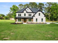 Beautiful two-story home with a manicured lawn and tasteful landscaping at 2339 Eastwood Dr, Snellville, GA 30078