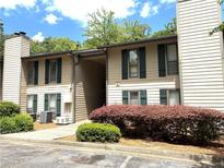 Charming two-story condo with green shutters and well-maintained landscaping at 9400 Roberts Dr # 7M, Atlanta, GA 30350