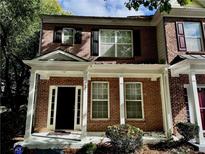 Charming brick townhouse with a welcoming front porch and classic architectural details at 4842 Hairston Park Sq, Stone Mountain, GA 30083