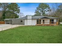 Charming one-story home with a well-maintained lawn, covered porch, and spacious carport at 4166 Idlevale Dr, Tucker, GA 30084