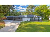 Charming one-story home with a covered carport, front porch, and a well-maintained front lawn at 4166 Idlevale Dr, Tucker, GA 30084