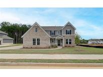 Charming two-story home with a mix of brick and gray siding, showcasing its appealing exterior at 234 Linford Dr, Locust Grove, GA 30248