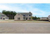 Beautiful new construction home featuring a mix of brick and siding and a manicured lawn at 234 Linford Dr, Locust Grove, GA 30248