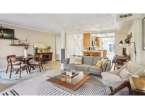 Open-concept living and dining area boasts lots of space and natural light, perfect for modern living at 3268 Clairmont Ne, Brookhaven, GA 30329