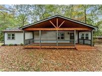Charming home featuring a covered porch with wood beams and ample natural light and an inviting entrance at 2205 Stockbridge Se Dr, Atlanta, GA 30316
