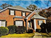 Charming brick home featuring a manicured lawn, black window shutters, and a welcoming entrance at 1019 Henna Se Ct, Conyers, GA 30013