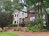 Charming brick home with manicured front yard, mature trees, and inviting curb appeal at 3298 Robinson Oaks Ne Way, Marietta, GA 30062