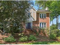 Charming two-story home with a combination brick and stucco facade, featuring a landscaped front yard at 3298 Robinson Oaks Ne Way, Marietta, GA 30062