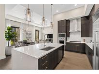 Modern kitchen featuring a large island, stainless steel appliances, and stylish pendant lighting at 40 12Th Ne St # 1704, Atlanta, GA 30309