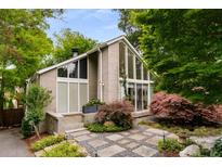Stunning home featuring a modern design, beautiful landscaping, and expansive windows letting in natural light at 318 5Th Ne St, Atlanta, GA 30308