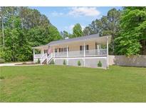 Charming ranch home with a welcoming front porch and a well-manicured lawn at 37 Winesap Ct, Temple, GA 30179