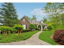 Charming stone and siding home featuring a manicured lawn and walkway at 6125 Fouts Mill Rd, Douglasville, GA 30135