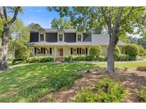 Charming home with a welcoming front porch and beautifully landscaped front yard at 3527 Starwood Sw Trl, Lilburn, GA 30047