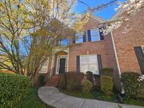 Charming brick two-story home with black shutters, landscaped yard, and stone walkway at 4091 Oberon Se Ct, Smyrna, GA 30080