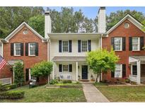 Charming townhome with brick accents, a manicured lawn and beautiful landscaping at 3992 Camden Way, Alpharetta, GA 30005
