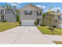 Charming two-story home featuring gray siding, a two-car garage, and a well-manicured front yard at 3475 Ridge Hill Pkwy, Douglasville, GA 30135
