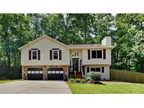 Charming split-level home featuring a two-car garage and a well-maintained front yard at 3445 Huntington Ct, Douglasville, GA 30134