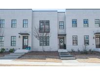 Modern townhome exterior featuring a light brick facade and well-manicured front yards at 3611 Ridgeway Rd, Duluth, GA 30096