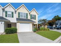 Charming townhome with a one-car garage, green shutters, and well-manicured front lawn at 6918 Gallant Se Cir # 22, Mableton, GA 30126