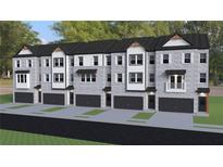 Modern townhomes featuring gray brick, black accents, individual garages, and manicured lawns at 2 Rock Park Way # 13, Tucker, GA 30084