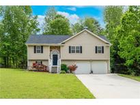 Charming split-level home with a two-car garage and a well-maintained lawn at 236 Fairview Dr, Dallas, GA 30157