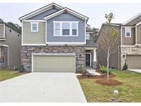 Charming two-story home featuring a stone facade, two-car garage, and well-maintained front lawn at 3305 Morgan Rd, Buford, GA 30519
