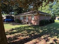 Charming, single-story brick home with mature landscaping and ample natural light at 1215 Sheppard Pl, Stone Mountain, GA 30083