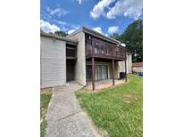 Exterior of building with a brown balcony, sliding glass doors and grassy lawn at 3575 Oakvale Rd # 1103, Decatur, GA 30034