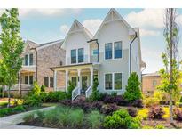 Charming two-story home with a welcoming front porch and professionally landscaped yard at 750 Tannery Cmn, Alpharetta, GA 30009