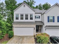 Charming two-story townhome featuring a two-car garage and well-maintained landscaping at 218 Piedmont Cir, Canton, GA 30114
