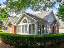 Charming home with a sunny enclosed porch, shuttered windows, and mature landscaping at 174 Vintage Club Cir, Marietta, GA 30066