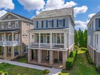 Charming two-story home with a welcoming front porch, great neighborhood, and manicured landscaping at 7455 Cordery Rd, Cumming, GA 30040