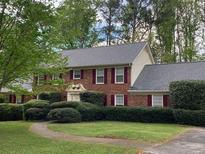 Charming two-story brick home with manicured landscaping and a well-maintained lawn at 5271 Vernon Lake Dr, Atlanta, GA 30338