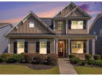 Charming two-story home featuring well-manicured landscaping, classic shutters, and a welcoming front porch at 1580 Johnson Nw Rd, Atlanta, GA 30318