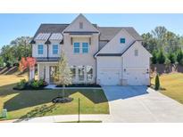 Beautiful two-story home with a two car garage, manicured lawn, and lovely landscaping at 3440 Carswell Bnd, Cumming, GA 30028