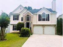 Charming two-story home with manicured lawn, two-car garage, and welcoming curb appeal at 1015 Crest Ridge Sw Pl, Marietta, GA 30060