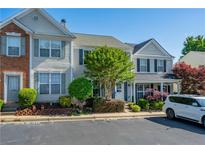 Inviting townhome with well-maintained landscaping, charming shutters, and convenient parking at 1240 Kilmington Ct, Alpharetta, GA 30009