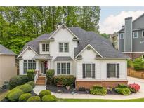 Charming two-story home with brick accents, lush landscaping, and a welcoming entrance at 690 Sienna Dr, Cumming, GA 30040
