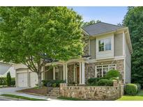 Charming two-story home featuring stone accents, a welcoming front porch, and a well-manicured lawn at 3687 Canyon Ridge Ne Ct, Brookhaven, GA 30319