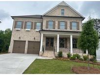 Charming two-story brick home featuring a welcoming front porch and a two-car garage at 5247 Flannery Chase Sw, Powder Springs, GA 30127