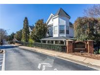 Beautiful townhome exterior with brick sign, black iron fence, and well-maintained landscaping at 951 Glenwood Se Ave # 1805, Atlanta, GA 30316