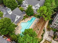 Aerial view of the community pool surrounded by lush greenery and lounge chairs at 951 Glenwood Se Ave # 1805, Atlanta, GA 30316