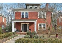 Charming two-story red brick home with inviting front porch and professionally landscaped front yard at 1241 Briarcliff Ne Rd, Atlanta, GA 30306